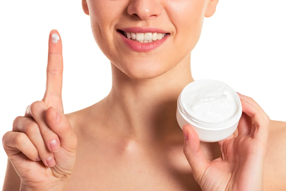a woman is showing arnica cream after lip fillers