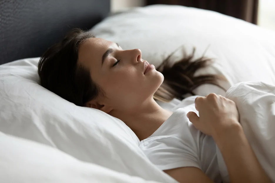 a woman sleeping on her back after lip fillers